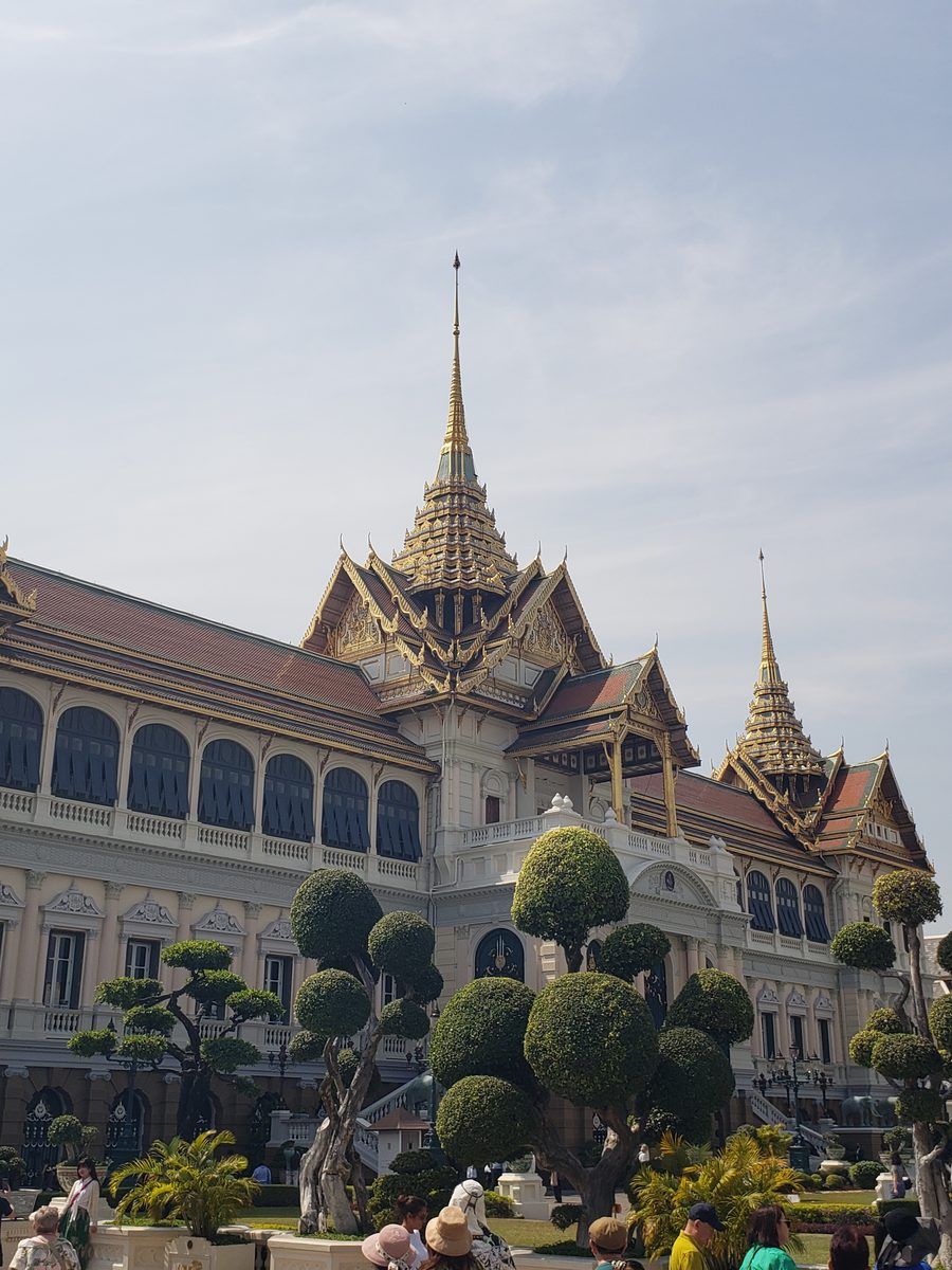 The Grand Palace seen through spherical topiary on the lawn