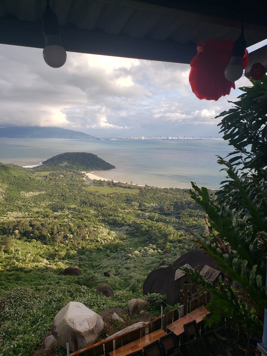 Da Nang across the bay from a hillside terrace, a red lantern in the frame